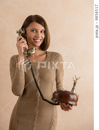 Happy elegant woman talking on retro telephone 9856517