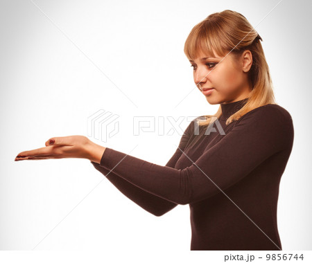 blond woman showing open hand holding black 9856744