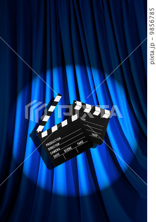 Movie clapper board against curtain 9856785