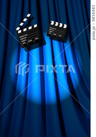 Movie clapper board against curtain 9856985