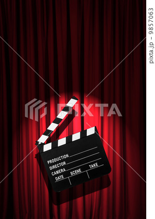 Movie clapper board against curtain 9857063