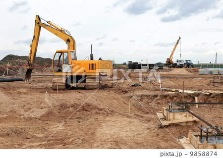 yellow excavator on a construction site 9858874