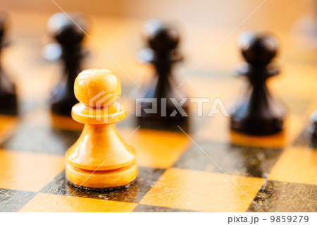 White and black chess pawns standing on chessboard White and black chess pawns standing on chessboard 9859279