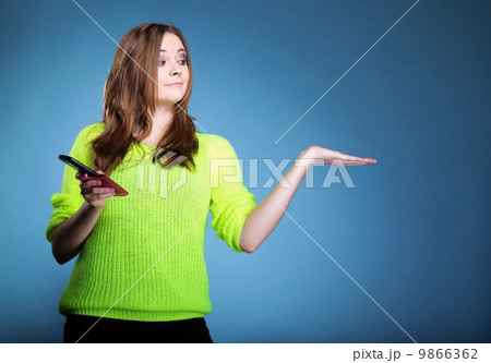 Happy girl with mobile phone open palm for product Happy girl with mobile phone open palm for product 9866362