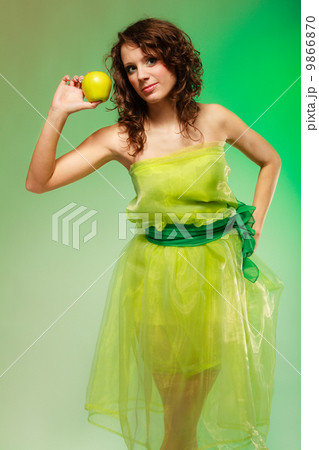 Spring or summer food. Woman girl in green dress holding apples Spring or summer food. Woman girl in green dress holding apples 9866870