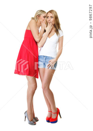 Gossiping friends, two women sharing a secret 9867297