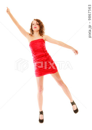 Full length woman in elegant red dress holding imaginary balloons and flying 9867563