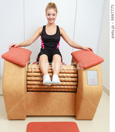 Girl in sportwear on relax massage equipment healthy spa salon Girl in sportwear on relax massage equipment healthy spa salon 9867775