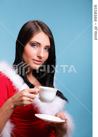 beautiful girl santa claus Girl blowing hot drink beautiful girl santa claus Girl blowing hot drink 9868036
