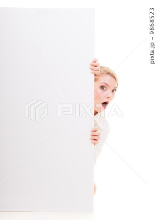 Surprised blonde girl with blank presentation board banner sign. Surprised blonde girl with blank presentation board banner sign. 9868523