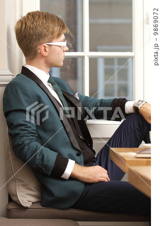 Young handsome stylish man in cafe 9869072