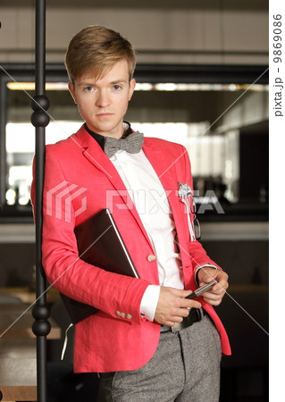 Young handsome stylish man posing indoor 9869086
