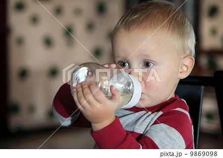 baby boy having his bottle 9869098