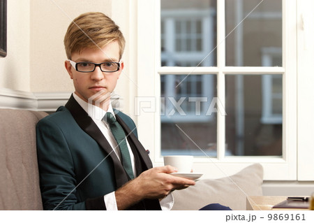 Young handsome stylish man in cafe with coffee Young handsome stylish man in cafe with coffee 9869161