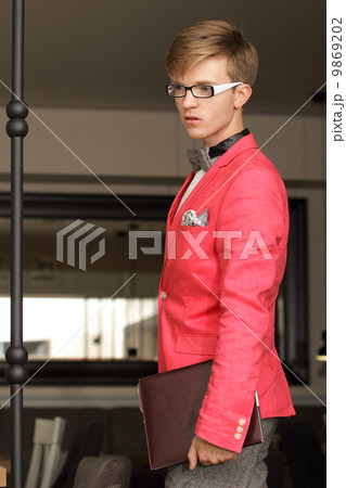Young handsome stylish man posing indoor Young handsome stylish man posing indoor 9869202