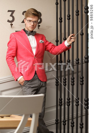 Young handsome stylish man posing indoor 9869266