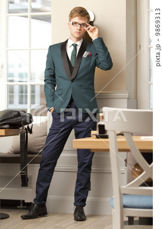 Young handsome stylish man in trendy cafe 9869313