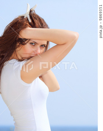young woman on seacoast with shell in hand young woman on seacoast with shell in hand 9869351