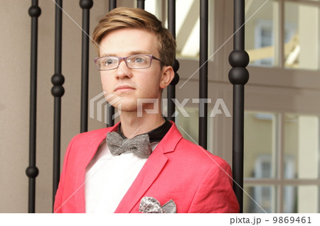 Young handsome stylish man posing indoor Young handsome stylish man posing indoor 9869461