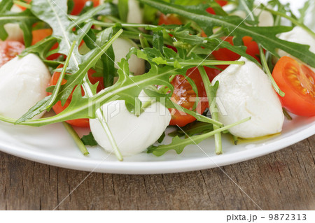 salad from arugula tomatos and baby mozzarella salad from arugula tomatos and baby mozzarella 9872313