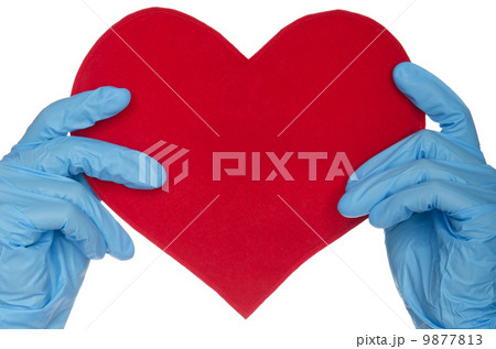 Two hands in blue medical gloves and heart 9877813