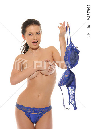 Smiling sexy woman takes off bra 9877947