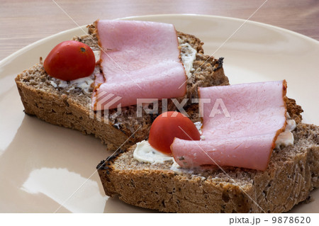 Tasty toasts with butter, ham and cherry tomatoes 9878620