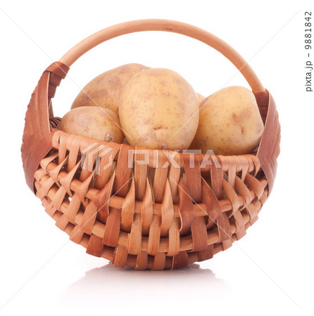Potato tuber  in wicker basket isolated on white background 9881842