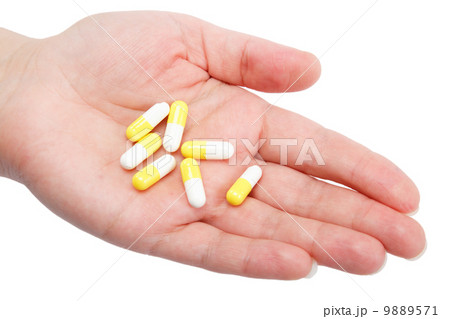 Pills in woman hand isolated on white background 9889571