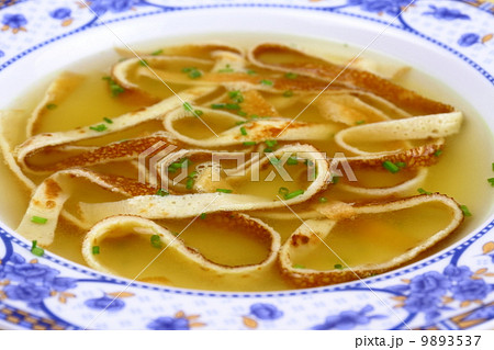 Pancake soup in blue plate, soft focus Pancake soup in blue plate, soft focus 9893537