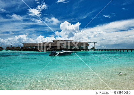 Beautiful island beach with motor boat Beautiful island beach with motor boat 9894086