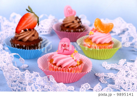 Appetizing cupcakes with angel, heart, tangerine, strawberry 9895141