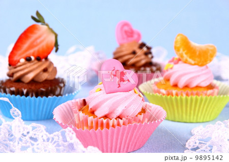 Appetizing cupcakes with angel, heart, tangerine, strawberry 9895142