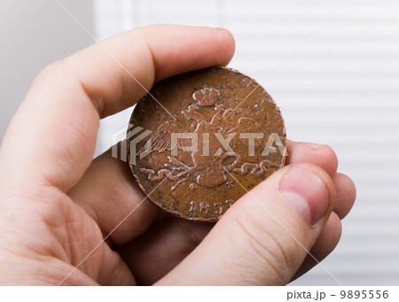old coin in hand 9895556