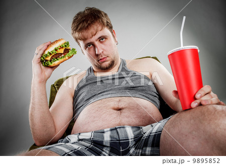 Fat man eating hamburger 9895852