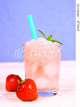 Strawberry slush in glass with straw on blue background 9896102