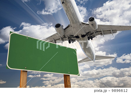 Blank Green Road Sign and Airplane Above Blank Green Road Sign and Airplane Above 9896612