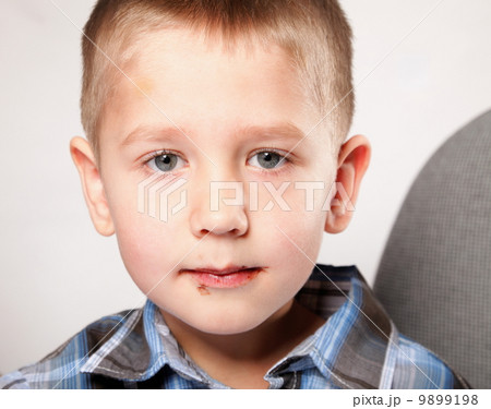 cute little boy with a chocolate on the face cute little boy with a chocolate on the face 9899198