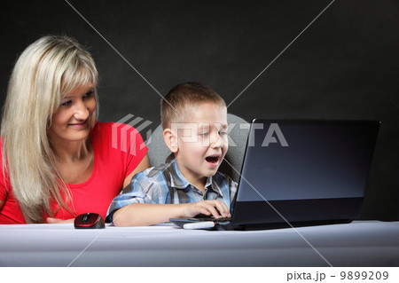 mother with son looking on the laptop mother with son looking on the laptop 9899209