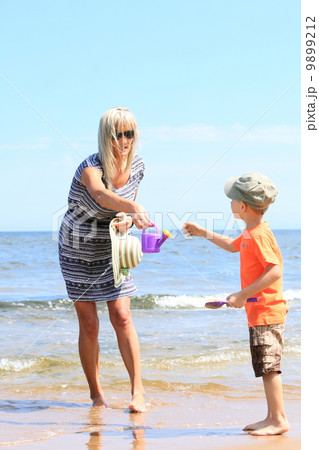 happy mother and son playing on beach happy mother and son playing on beach 9899212