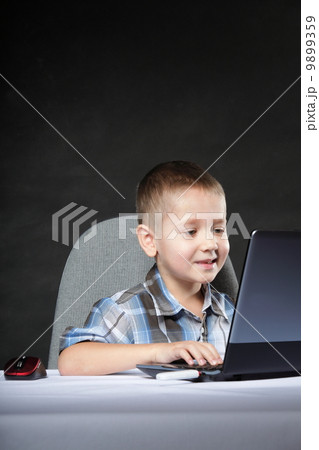 Computer addiction child with laptop notebook Computer addiction child with laptop notebook 9899359