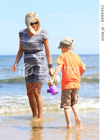 happy mother and son playing on beach happy mother and son playing on beach 9899402