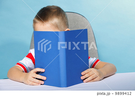 child boy kid reading a book on blue child boy kid reading a book on blue 9899412