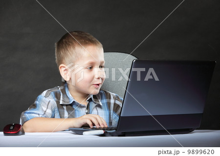 Computer addiction child with laptop notebook 9899620