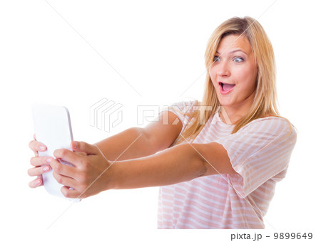 Surprised emotional girl using tablet touchpad e-book e-reader 9899649