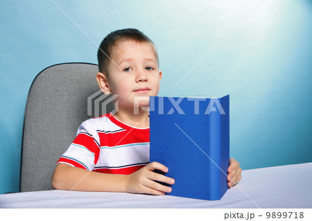 child boy kid reading a book on blue 9899718