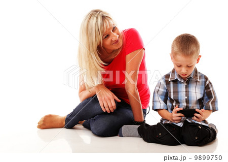 Mother and son playing video game on smart phone Mother and son playing video game on smart phone 9899750