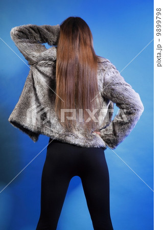 young woman in fur long hair blue background young woman in fur long hair blue background 9899798