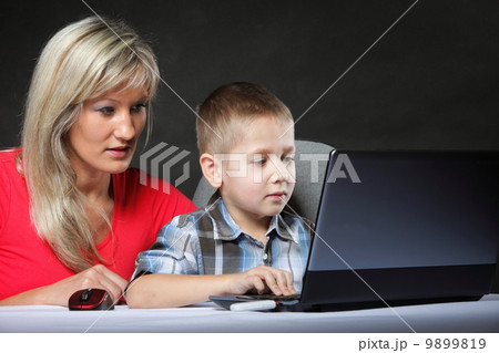 mother with son looking on the laptop 9899819