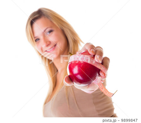 Time for diet slimming. Woman with apple and measuring tape Time for diet slimming. Woman with apple and measuring tape 9899847